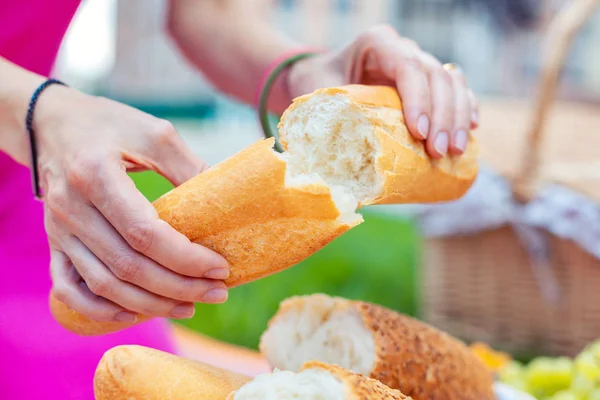 Loaf of bread being torn in two pieces — Stock Photo, Image