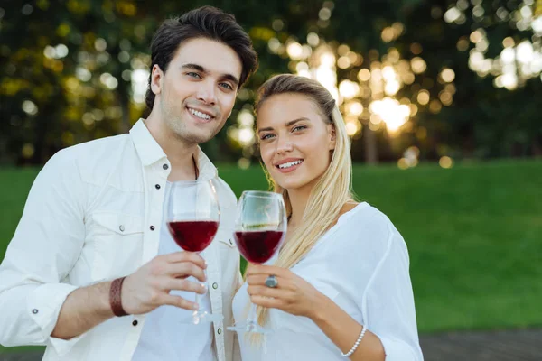 Feliz joven pareja bebiendo vino tinto juntos — Foto de Stock