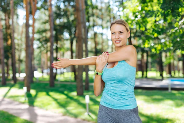 Cheerful positive young woman moving her body — Stock Photo, Image