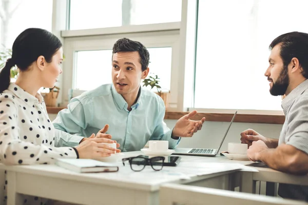 Buena gente inteligente sentada a la mesa — Foto de Stock