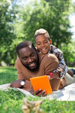 Neşeli yakışıklı tablet ekrana bakarak