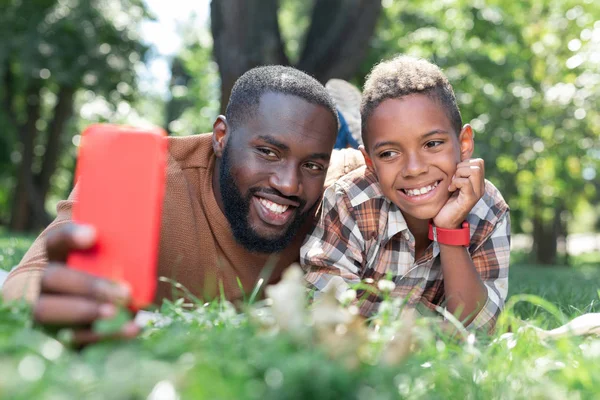 Alegre encantado padre e hijo sonriendo para una foto —  Fotos de Stock