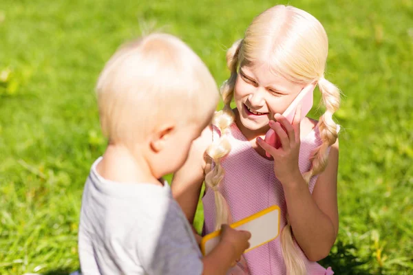 High-spirited children speaking on the toy phone — Stock Photo, Image