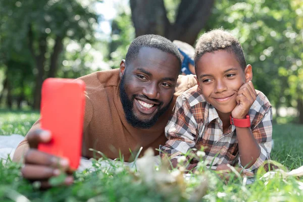 Delighted positive father and son taking selfies — Stock Photo, Image