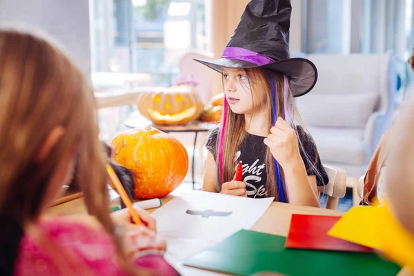 Beautiful girl wearing black wizard hat for Halloween drawing little black bat