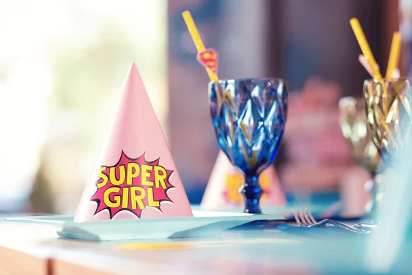 Pink party hat for super girl placed near the glasses — Stock Photo, Image
