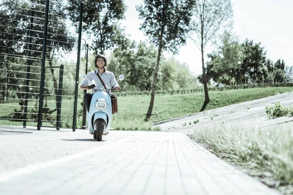 Enthusiastic male student heading to university on motorbike — Stock Photo, Image