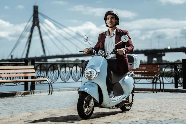 Estudiante masculino soñador que viaja en moto por la ciudad — Foto de Stock