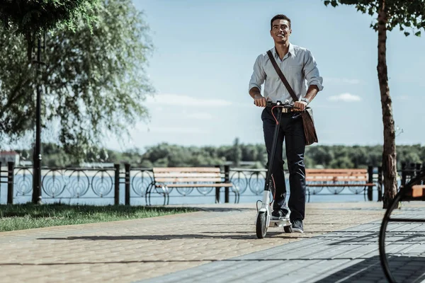 Pretty enthusiastic guy getting used to electric scooter — Stock Photo, Image
