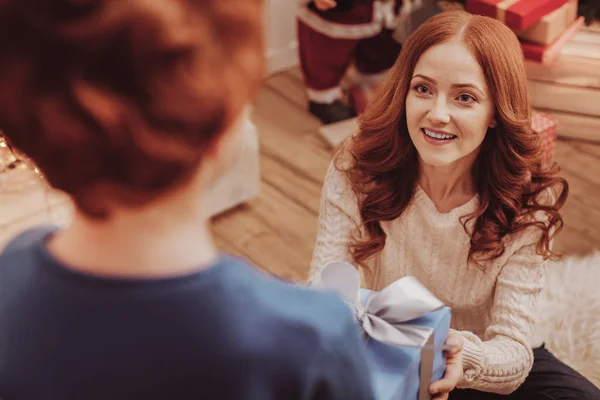 Close up of delighted mother giving a present for her child — Stock Photo, Image