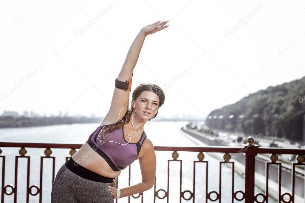 Nice active woman holding her hand up