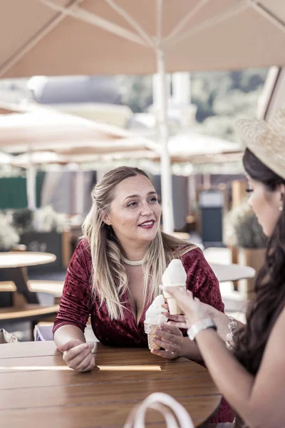 Pleasant nice woman offering an ice cream cone to her friend — Stock Photo, Image