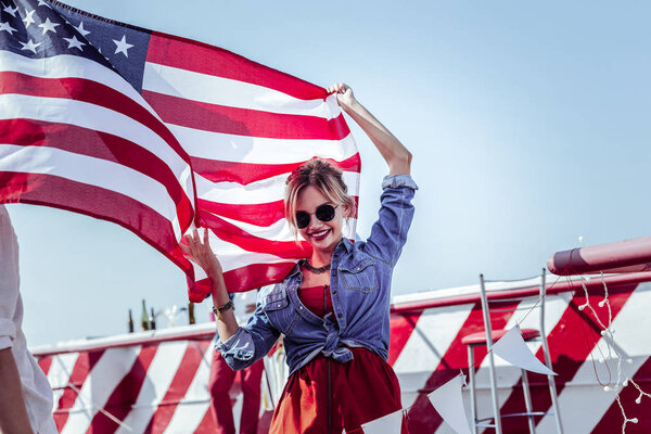 Amazing blonde female person demonstrating American flag