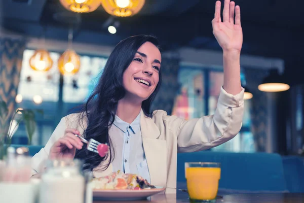 Pretty longhaired female person calling her waiter — Stock Photo, Image