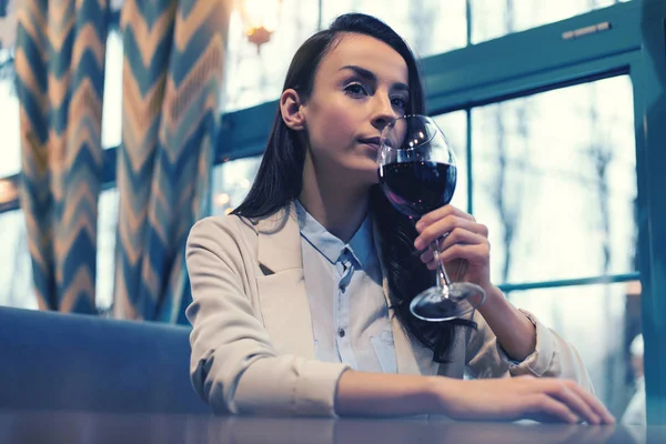 Femme détendue dégustant un vin rouge savoureux — Photo