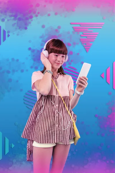 Pleased appealing girl enjoying music on background — Stock Photo, Image