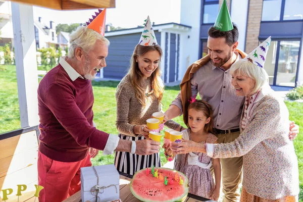 Positive delighted people celebrating birthday of their kid