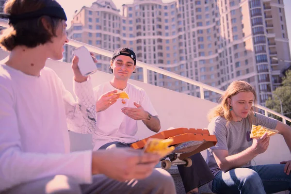 Relaxed brunette male communicating with his partners