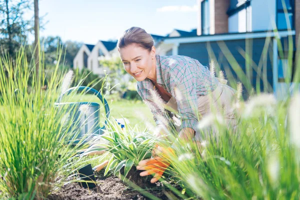 Loving family woman relaxing on weekend while working in garden bed — Stok Foto