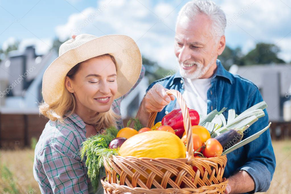 Blonde-haired family woman enjoying the view of their own harvest