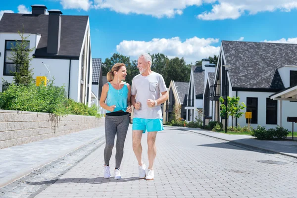 Bearded mature husband joining his beautiful slim wife running in the morning — Stock Photo, Image