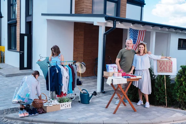 Generous and kind-hearted husband and wife feeling contended during yard sale — Stock Photo, Image