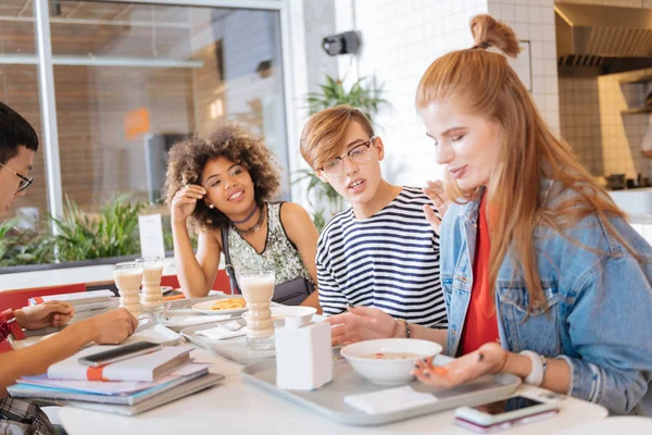 Charming longhaired girl looking at her tray — Stock Photo, Image