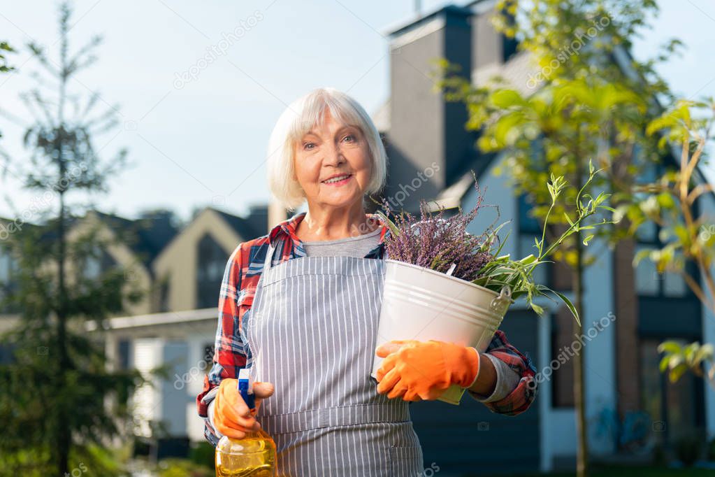 Beautiful old woman looking at you attentively