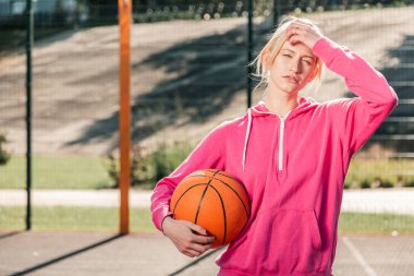 Nice young blonde woman wearing pink sportswear clipart