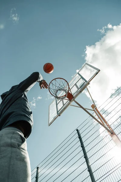 Low angle of a ball flying to the basket — Stock Photo, Image