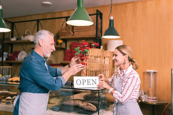 Blonde-haired woman looking at her husband while working together — Stock Photo, Image