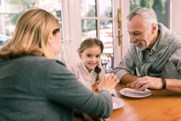 Happy grandparents taking their little cute granddaughter to the bakery — Stock Photo, Image