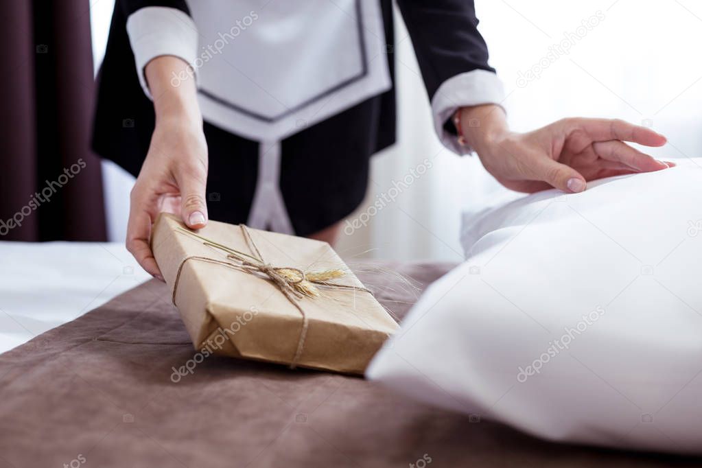Close up of a gift box being put under the pillow