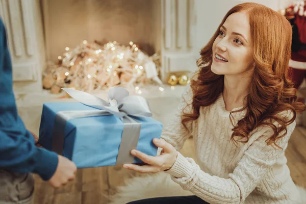 Charming young mommy taking present — Stock Photo, Image