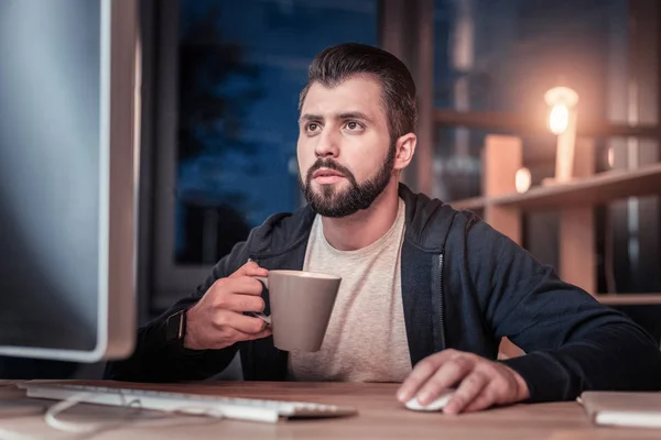 Competent bearded man working with his computer — Stock Photo, Image