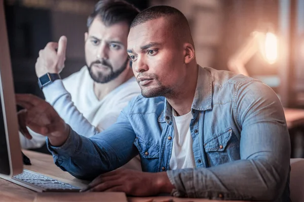 Uppmärksamma freelancer pekar på dator — Stockfoto