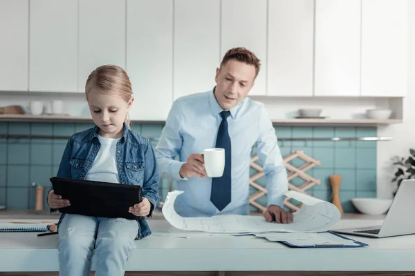 Chica ocupada grave sentado y usando la tableta . — Foto de Stock