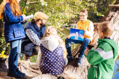 Kutup ayısı bir resimle tutan olumlu iyi çocuk