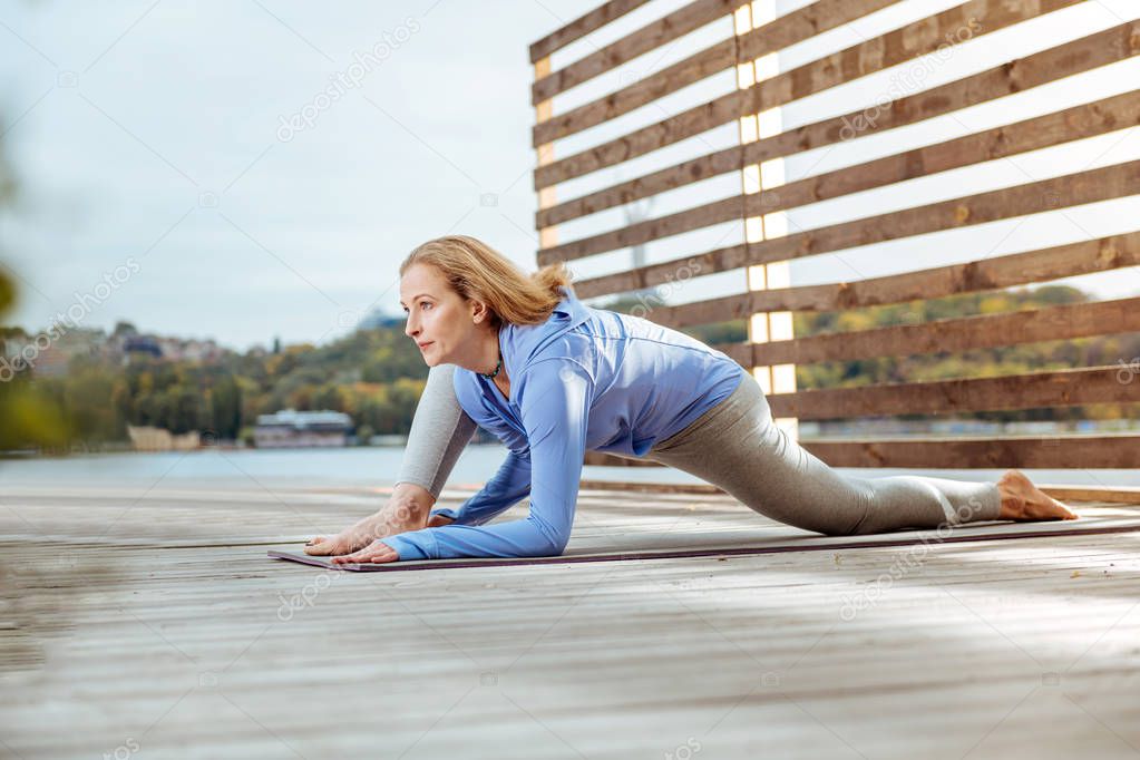 Woman stretching her muscles after doing morning exercises
