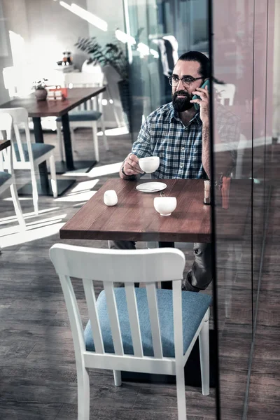 居心地の良いカフェテリアでコーヒー タイムを持つ黒髪の男のひげを生やした — ストック写真