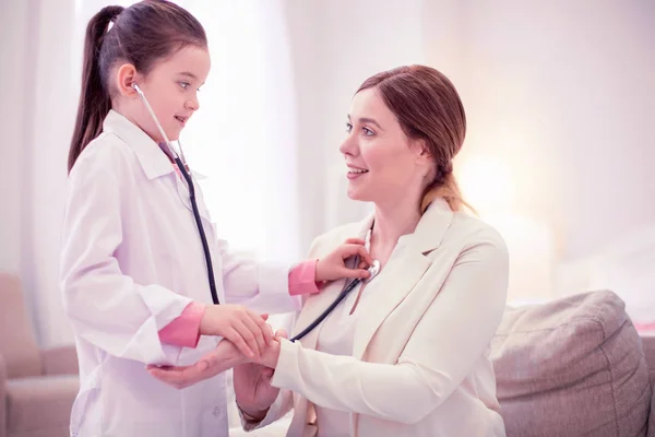 Cuidar médico da família brincando com seu cliente examinando menina — Fotografia de Stock