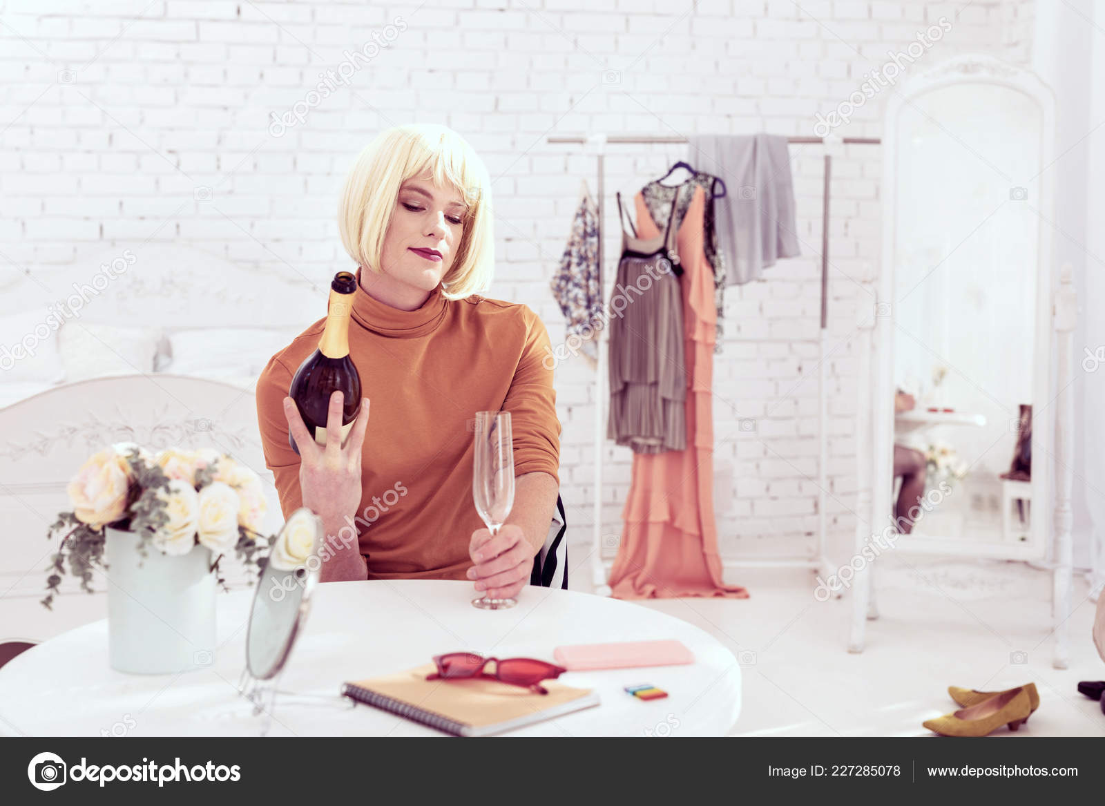 Cheerful Transgender Sitting In His Beauty Room Stock Photo