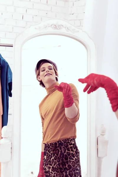 Smiling bright looking transgender showing off against the mirror — Stock Photo, Image