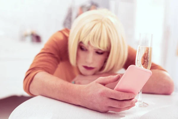 Sarışın peruk pembe cep telefonu taşıyan ile ilginç transseksüel — Stok fotoğraf
