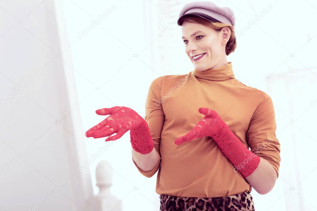 Joyful smiling transgender talking to himself being at home