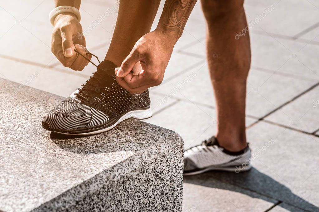 Close up of male hands lacing the shoes