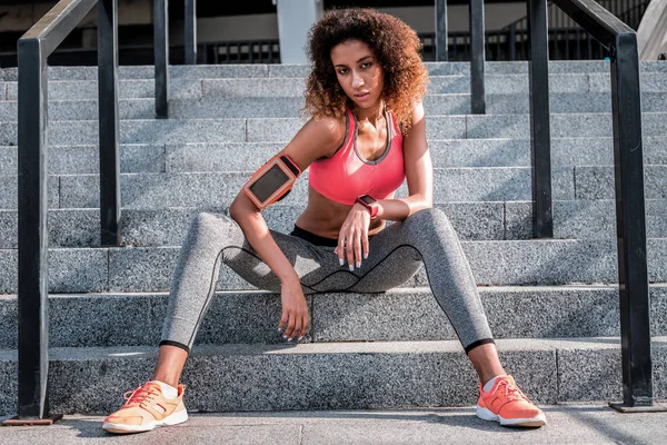 Pleasant young woman resting after a workout — Stock Photo, Image