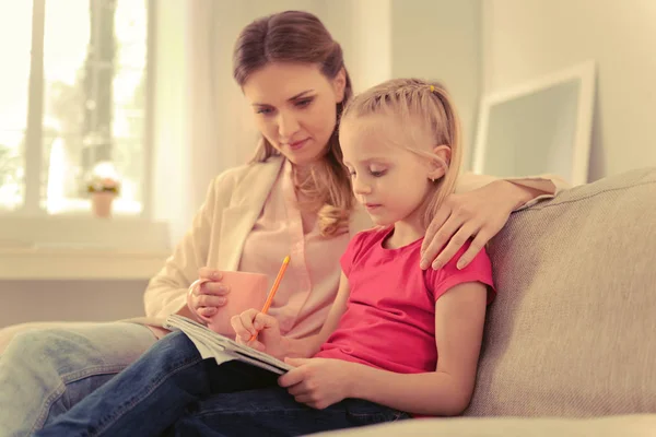 Smart serious girl doing her school home task — Stock Photo, Image