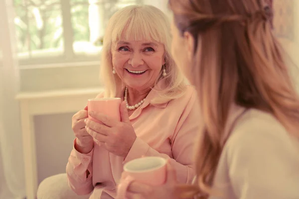 Delighted nice elderly woman visiting her daughter — Stock Photo, Image