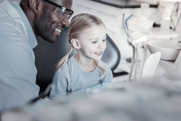 Gentile piccola femmina controllando il suo sorriso sano — Foto Stock